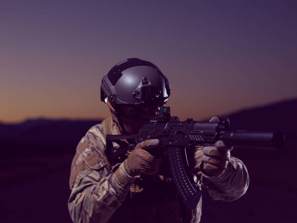 istock soldier with full combat gear in night mission 1307077665