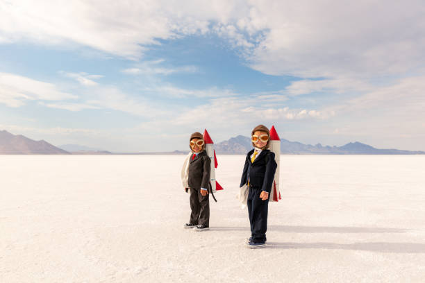 istock Two Young Business Boys Taking Flight 1307077769