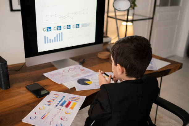 istock Humorous image of young boy working on a laptop computer 1307078632