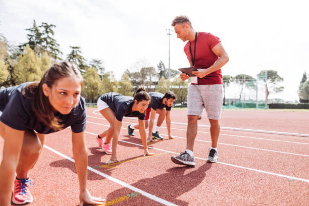 istock coach with runner on the track 1307078872