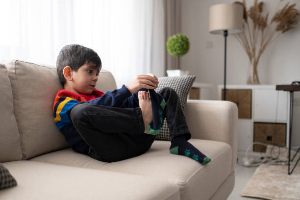 istock Adorable little boy trying to put a socks. 1307078935