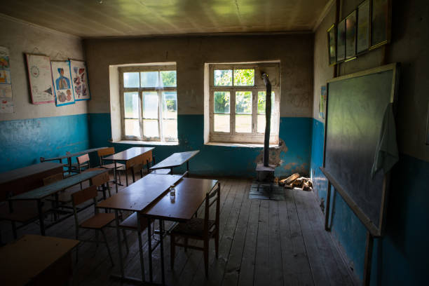 istock Old and abandoned school classroom interior, in black and white. 1307079798