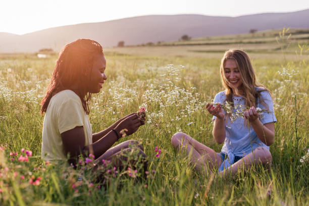 Carefree female friends enjoying together in the field