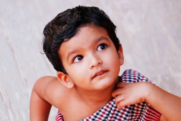 cute three year old indian baby boy in close up looking