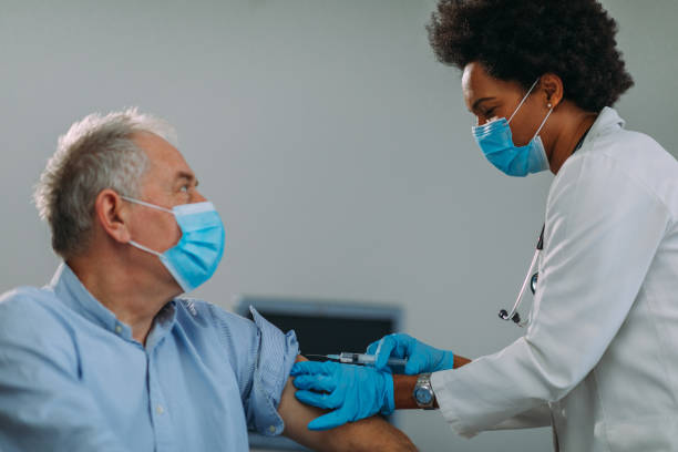 istock Senior man getting vaccinated at hospital 1307081992