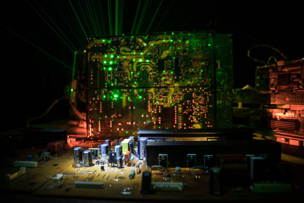 istock Stylized photo of an electronic microcircuit. Microcircuit, contacts, electronics, motherboard. Black background. Macro photography of electronic devices. 1307083017