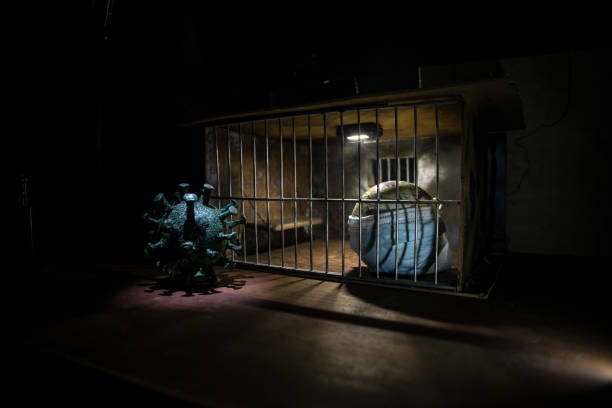 istock Prison or jail cell wall with window with bars, exterior perspective, COVID-19 corona virus disease pandemic outbreak, Coronavirus spreading among inmates, SARS-CoV-2 in correctional facility complex 1307083034