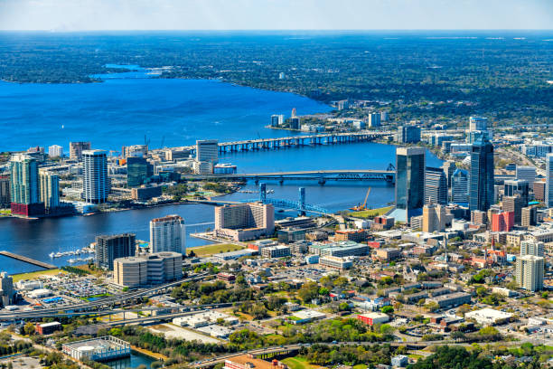 Jacksonville Skyline The urban skyline of Jacksonville, Florida with the St. John's River dividing the city shot from an altitude of about 1000 feet over the city. helicopter point of view photos stock pictures, royalty-free photos & images