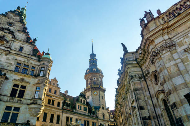 A beautiful view of a historical cityscape featuring notable architectural highlights along a serene riverside setting, under a partially cloudy sky, showcasing heritage and cultural significance.