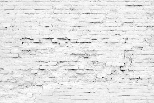 istock Old white gray ruined brick painted wall texture background, full frame 1307086491