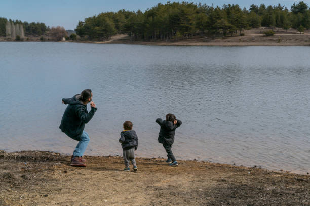 istock Father and sons have fun together by the lake. 1307088359