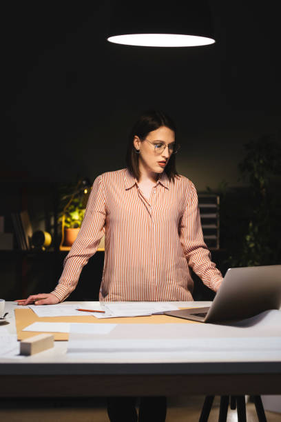 istock Pretty Young Businesswoman Working on Her Computer Late at Night 1307091789