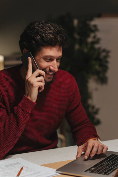 istock Smiling Young Entrepreneur Having a Phone Conversation at Work 1307091809