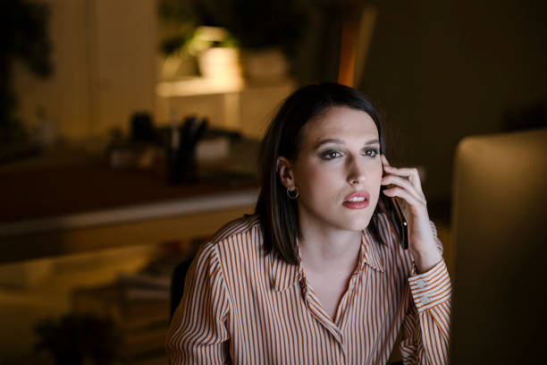 istock Young Businesswoman Making a Phone Call while Working on the Computer at the Office 1307091829