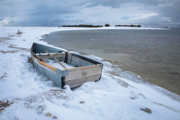 istock boat on the frozen beach 1307092527