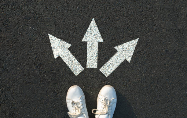 istock Woman standing near arrows 1307092529