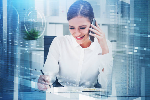 istock Smiling woman on phone and financial graphs 1307093959