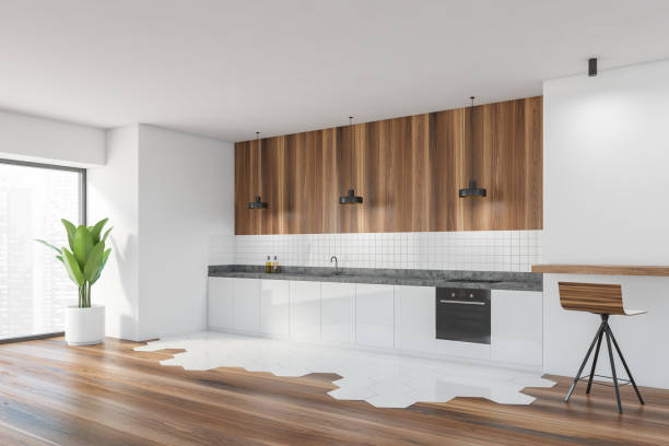 istock Modern kitchen interior with copy space on white wall, wooden countertops with a built in sink and a cooker. mock up. 1307094542