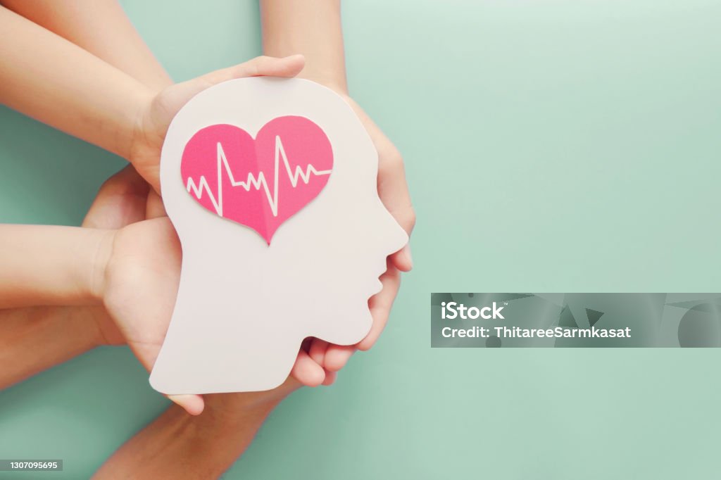 Adult and children hands holding paper brain and heart, brain stroke, world heart day, world mental health day, Alzheimer and wellness concept Mental Health Stock Photo