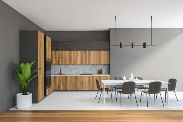 istock Grey room with kitchen set and dining table with grey chairs on white floor 1307095732