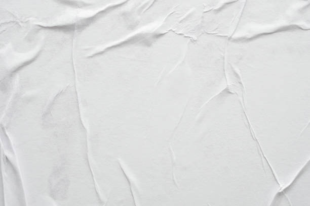 istock Blank white crumpled and creased paper poster texture background 1307098344