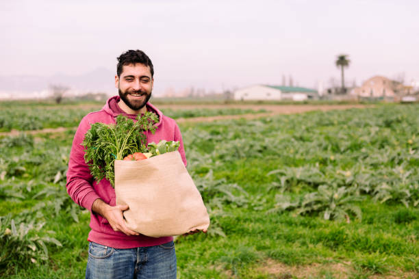 istock young farmer with a burlap bag with vegetables 1307098586