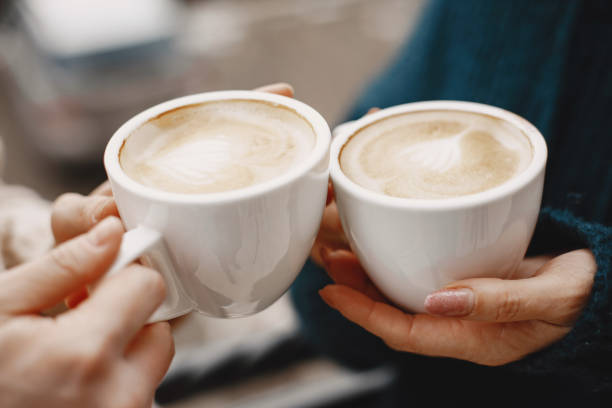 istock Daughter and middle-aged mother drinking coffee on balcony 1307100048
