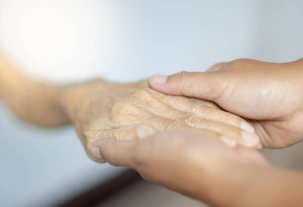 istock Female hand holding with her father for supporting senior old man in her house, while her father is patient and waiting for recover their health. 1307101363