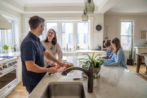 istock Parents Preparing Dinner At Home For The Family 1307103283