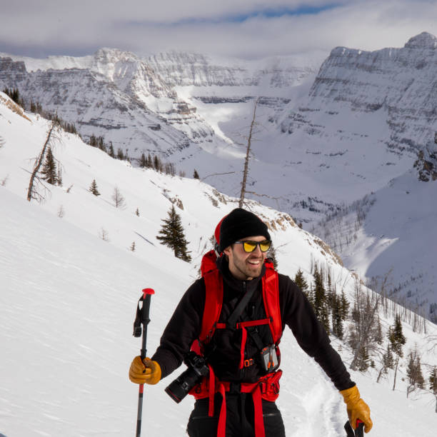 istock Backcountry skier takes a break from climbing up mountain 1307104136