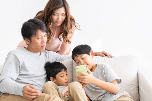 istock family looking at smart phone 1307110392