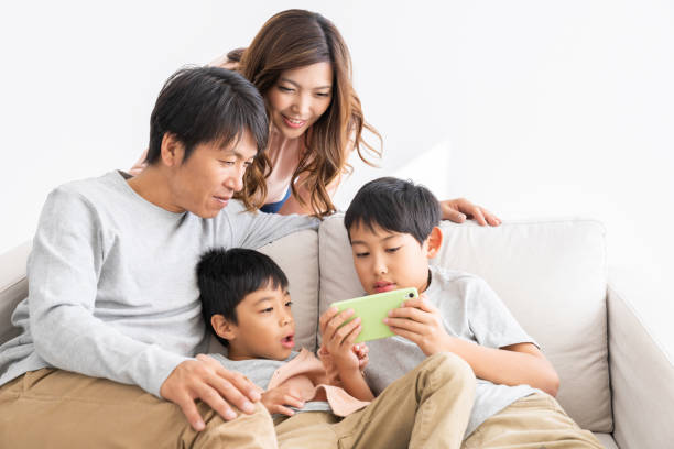 istock family looking at smart phone 1307110445
