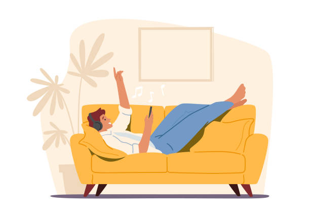 ilustrações de stock, clip art, desenhos animados e ícones de relaxed male character in headphones listening music on smartphone application lying on sofa. man relaxing enjoying life - young men illustrations