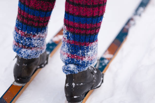 istock Woman's legs in vintage ski boots, standing on skis 1307112050