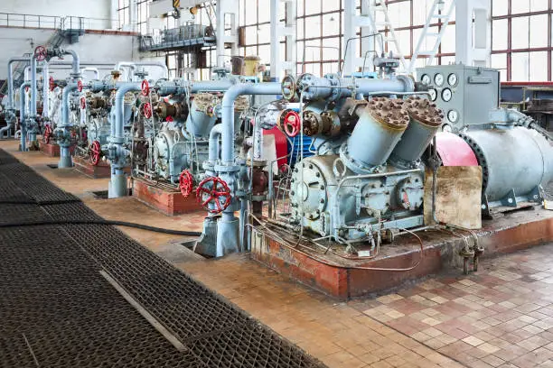 GRODNO, BELARUS - MAY 2020: Interior element of chemical enterprise ammonia reciprocating compressors with cylinders and electric motor with control panel with control devices and alarm systems.