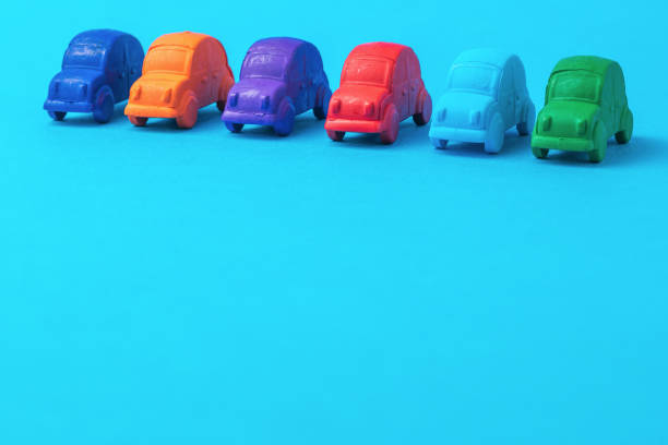 istock A row of several cars on a blue background. 1307118091
