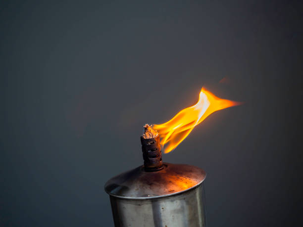 A garden torch flame on dark background. Oil lamp burning torch with blurred motion flame.