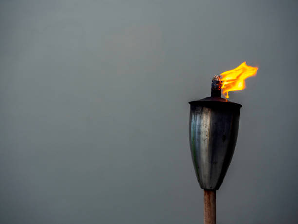 istock A garden torch flame on dark background. 1307120785