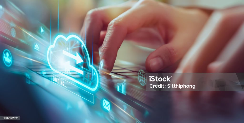 Cloud computing technology concept, Hand using laptop with upload data on internet storage. Cloud Computing Stock Photo