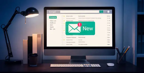 New email alert on computer, communication connection message to global letters in the workplace.