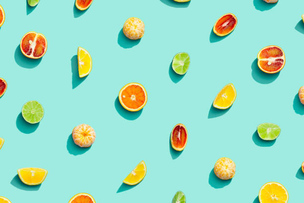 istock Colorful fruit pattern from fresh citrus, lemon, red orange, tangerine and lime on blue background. Summer food. 1307128708