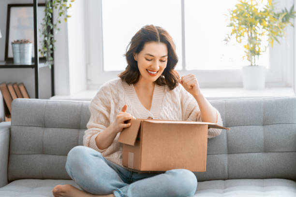 istock woman is unpacking cardboard 1307131235