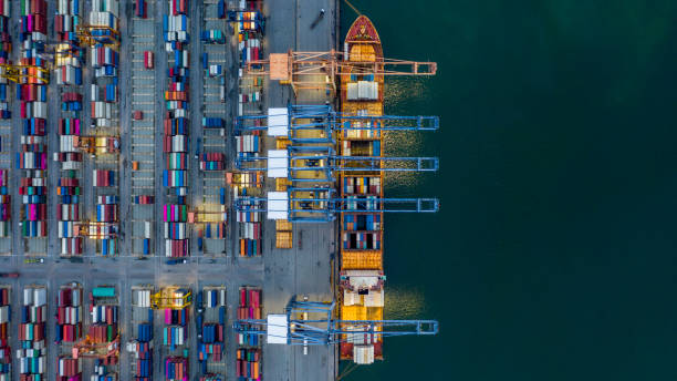 istock Aerial view container ship loaded in container terminal at night, Global business import export logistic and transportation, Commercial dock company cargo vessel freight shipping at night. 1307131472