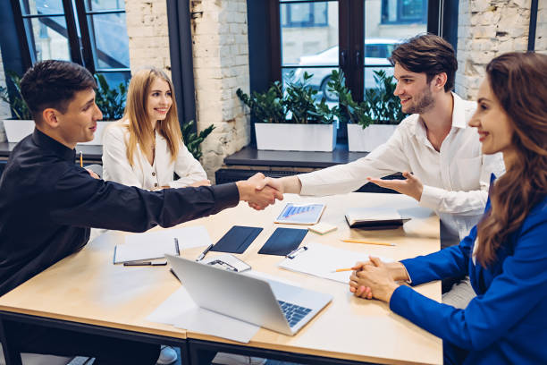 istock businessmen shaking hands in office 1307133179