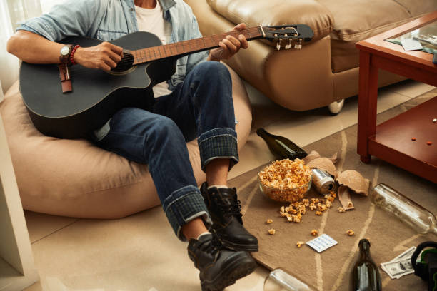 istock Man playing guitar at party 1307136094