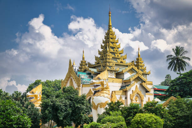 Shwedagon Pagoda Yangon Rangoon Myanmar Majestic Shwedagon Pagoda South Entrance Temple Pagoda with Buddhist Temple Dragon Guard Statues between green tropical trees under sunny summer sky. Yangon, Rangoon, Myanmar Burma, Asia. shwedagon pagoda pagoda gate entrance stock pictures, royalty-free photos & images