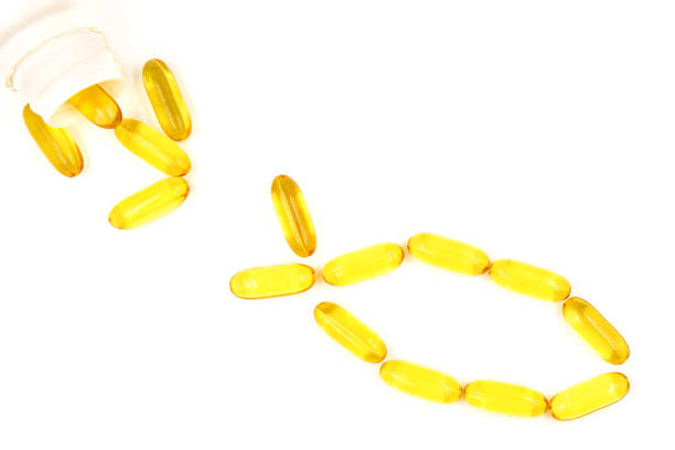 istock Omega-3 fish oil capsules in a shape of a fish. 1307139304