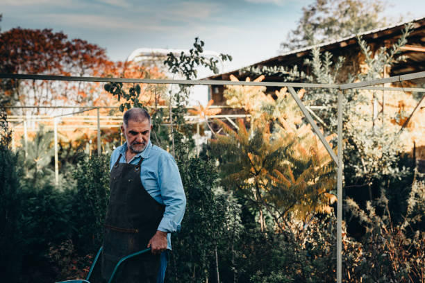 istock grandfather and grandson in tree nursery 1307140113