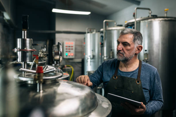 istock brewer working in mini craft brewery 1307141120