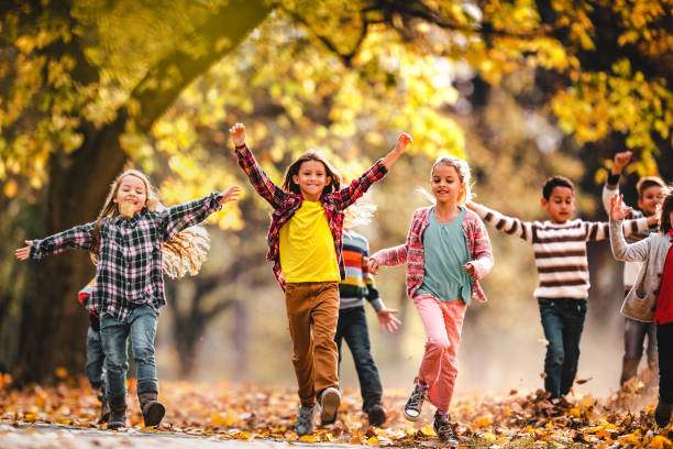 istock Playful children having fun while running in autumn day at the park. 1307141407